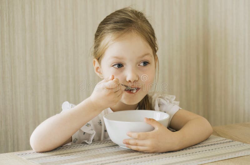 Girl serve porridge