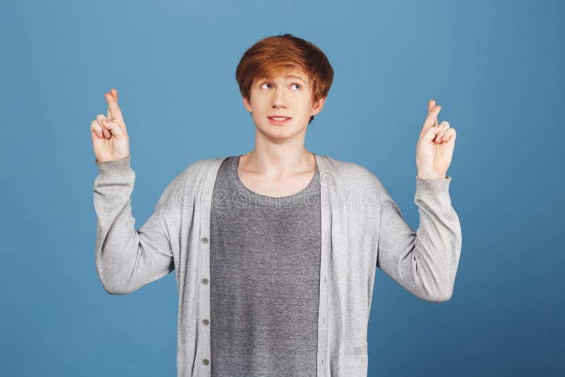 Mark young. Waiting for Exam Results. Boy with Freckles having shy expression pointing aside with finger. Copy Space..