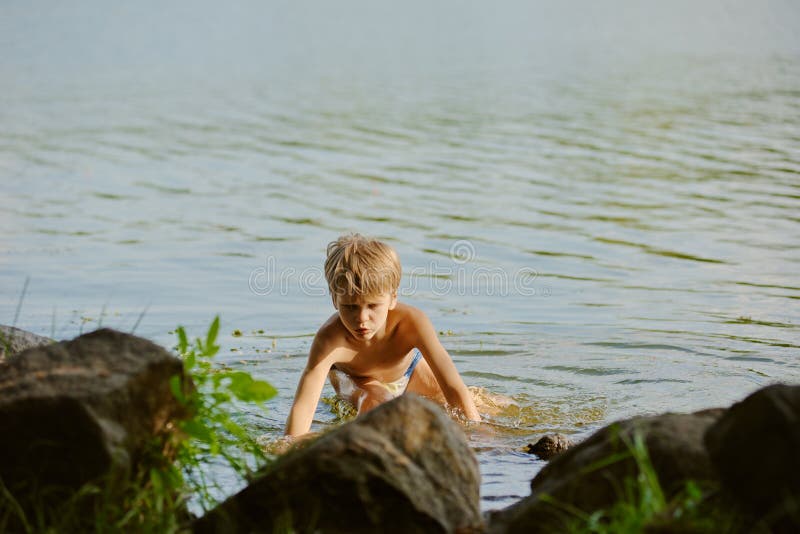 Boy Sitting by Lake in Boston Public Garden with Geese Stock Image - Image of lo