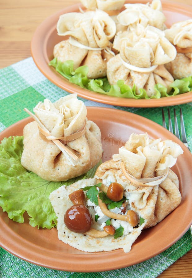 Блинные мешочки с грибами и сыром, стоковые картинки