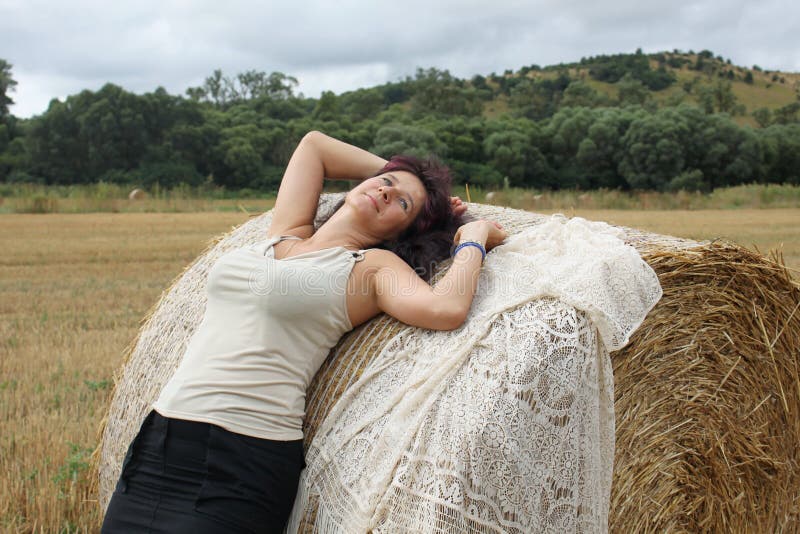 Девочки лежащие на сене. Портрет лежа на сене. Фото на сене лежит брюнетка. Девушка лежит на сене на животе.