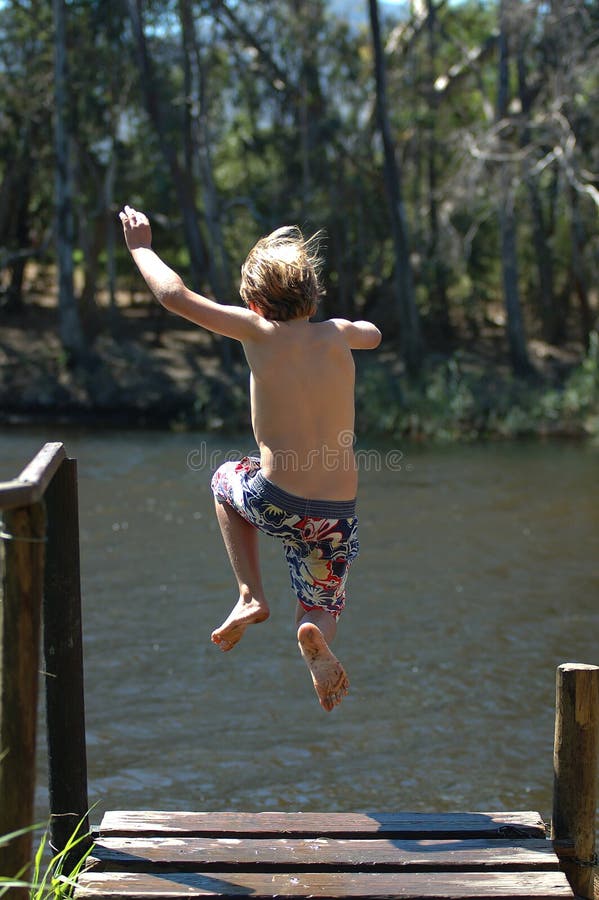 A Boy in Swimming Trunks Stands on the Sandy Shore Stock Photo - Image of europe