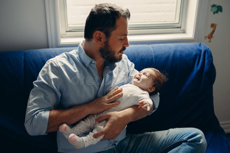 Caucasian father. Father holding Newborn.