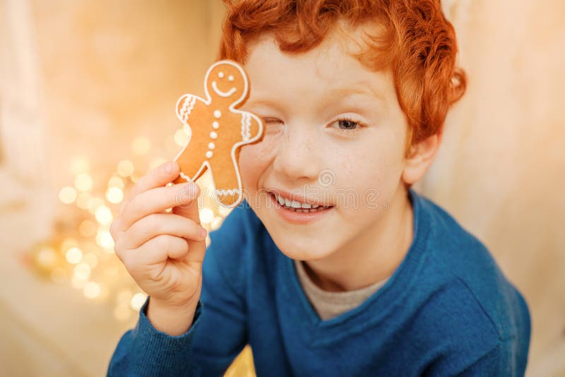 Пряник мальчик рыжий. Пряник человек. Adorable redhead Opening cookie outside.