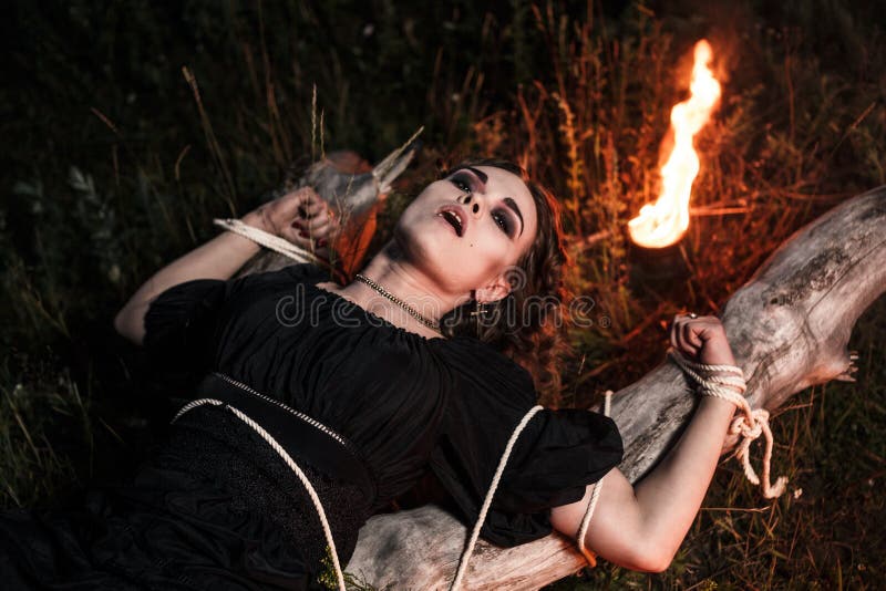 Картина ведьма прикуривает от костра