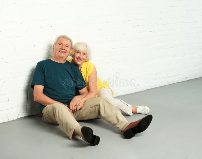 Mature Couple Sitting Back To Back On Floor High