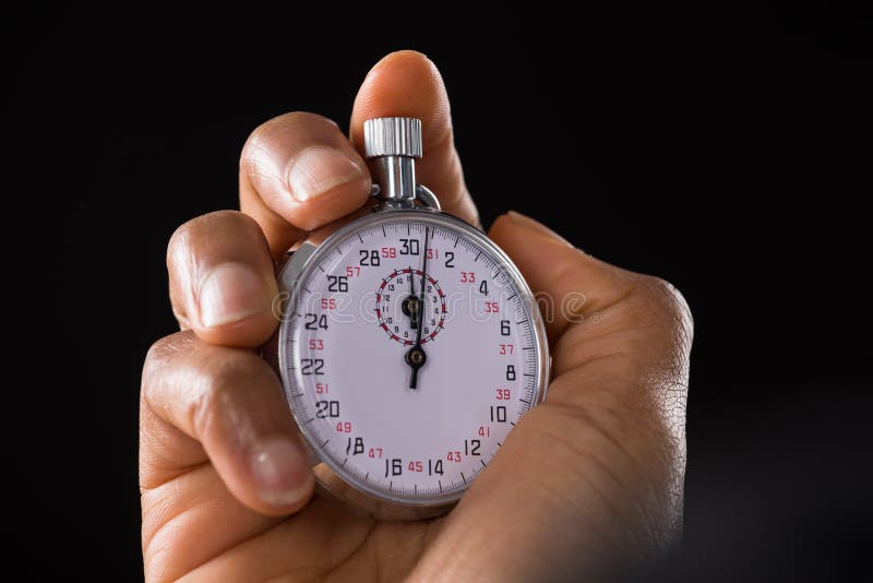 Через час стоп. Стоп часы. A hand holding a Stopwatch. Часы календарь Сток фото. Stop watching.