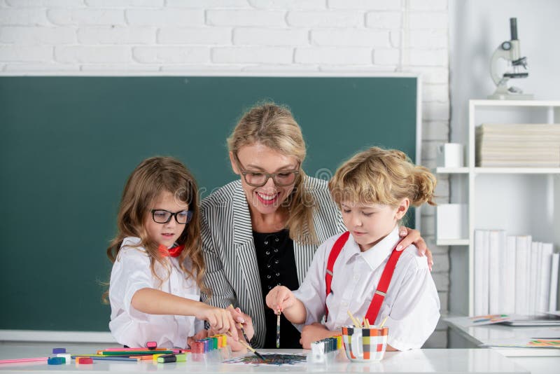 Первоклассник и учитель. Учитель и ученик. Учитель у доски. Учитель и ученица. Учитель учит ученицу.