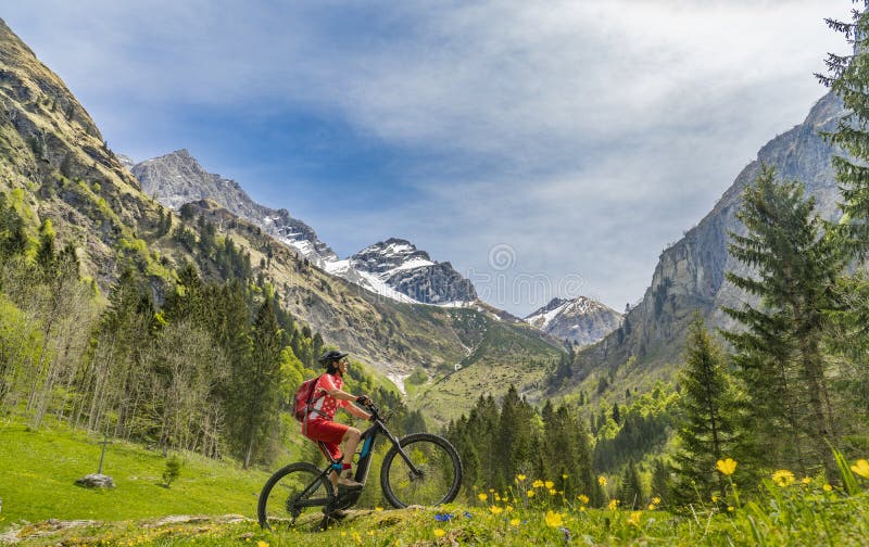 骑电动山地自行车的女子，在尼贝尔霍恩山下的阿尔卑斯山谷库存照片- 图片包括有女孩, 修改: 183287354