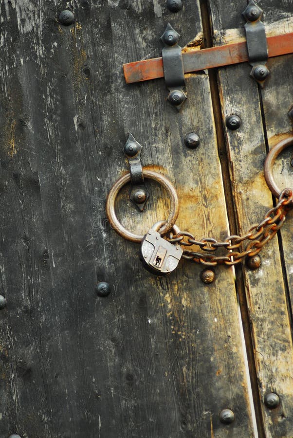 Padlock with chains on the old heavy castle doors. Padlock with chains on the old heavy castle doors