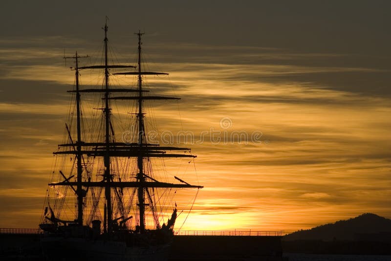 Sailboat sillouette under a stunning golden sky. Sailboat sillouette under a stunning golden sky