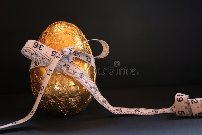Image of one easter egg with a tape measure wrapped around it, conceptual dieting - room left on image for text. Image of one easter egg with a tape measure wrapped around it, conceptual dieting - room left on image for text