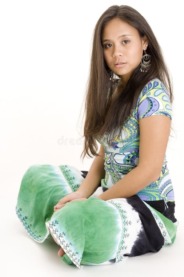 A pretty young asian woman in colorful skirt and top on white background. A pretty young asian woman in colorful skirt and top on white background