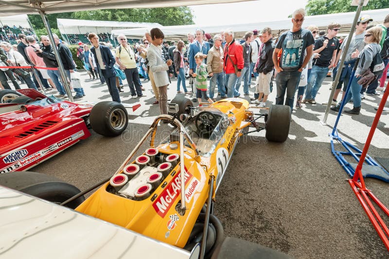 The public enjoying a collection of classic McLaren and Ferrari F1 racing cars in the service pits at the Festival of Speed motor-sport event held at Goodwood, UK on July 1, 2012. The public enjoying a collection of classic McLaren and Ferrari F1 racing cars in the service pits at the Festival of Speed motor-sport event held at Goodwood, UK on July 1, 2012