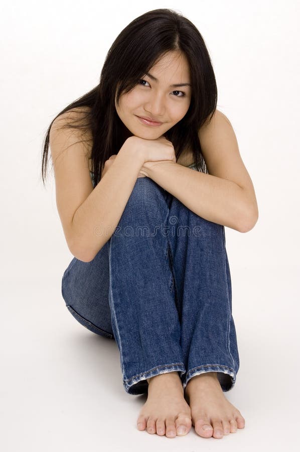 A beautiful young asian woman sitting on the floor. A beautiful young asian woman sitting on the floor