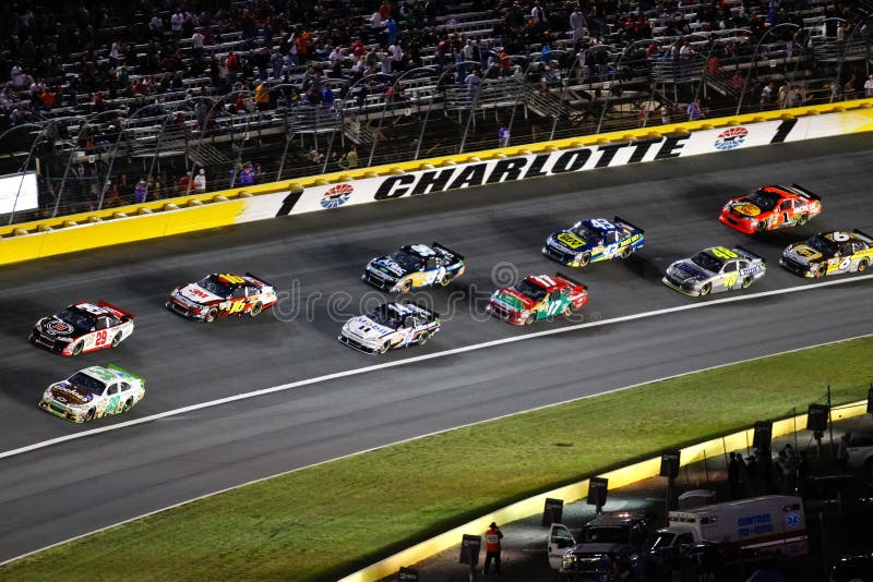 The main pack of cars rolls through turn 1 at the 2011 NASCAR Bank of America 500 at Charlotte Motor Speeday in Concord, North Carolina. The main pack of cars rolls through turn 1 at the 2011 NASCAR Bank of America 500 at Charlotte Motor Speeday in Concord, North Carolina.