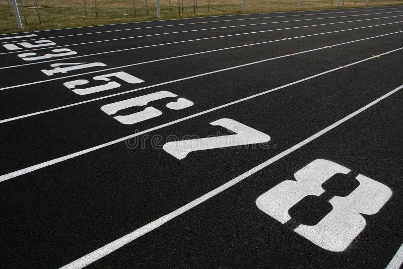 White and black numbered lanes 1-8 on track field. White and black numbered lanes 1-8 on track field.