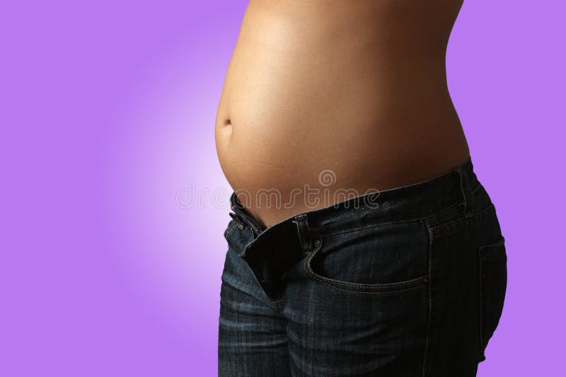 Close-up of a female torso at five months gestation, isolated on a gradient pink background. Close-up of a female torso at five months gestation, isolated on a gradient pink background.