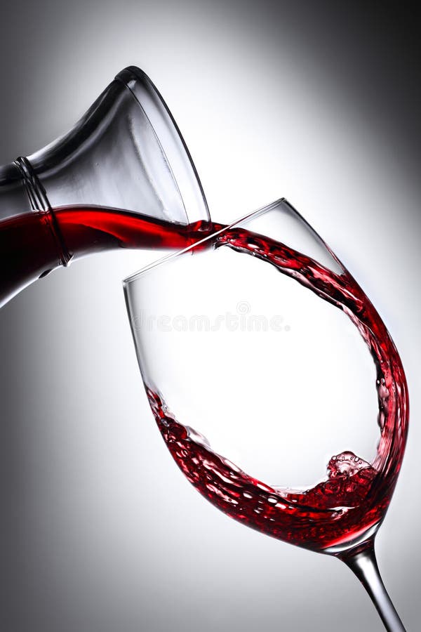 Red winde pouring from carafe into glass. Red winde pouring from carafe into glass