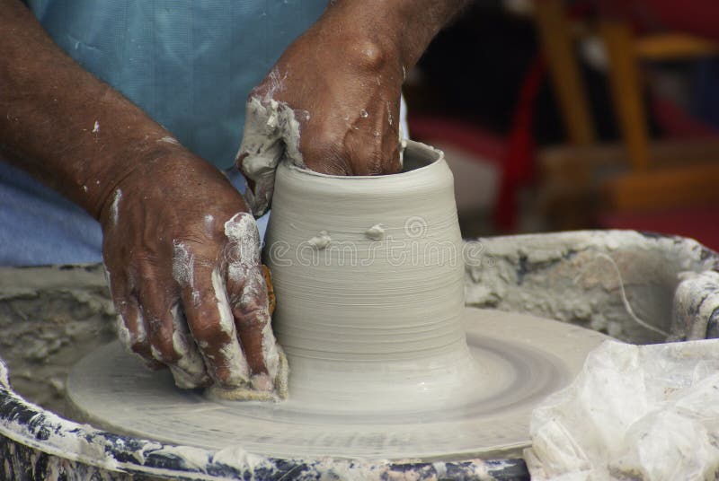 A Potter forms a vase during at Mumfest, New Bern, NC. A Potter forms a vase during at Mumfest, New Bern, NC