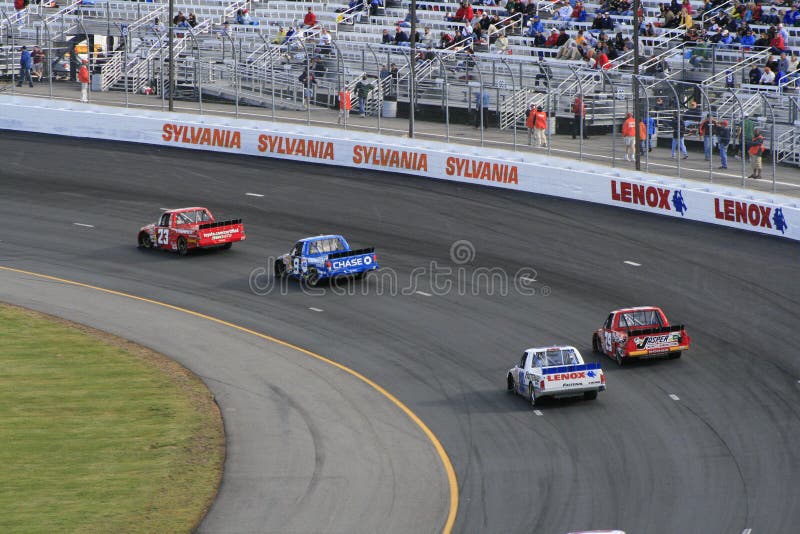 NASCAR Craftsman Truck competitors roar through the 1st turn at the 2007 Fall NASCAR Truck Race at New Hampshire International Speedway. NASCAR Craftsman Truck competitors roar through the 1st turn at the 2007 Fall NASCAR Truck Race at New Hampshire International Speedway.