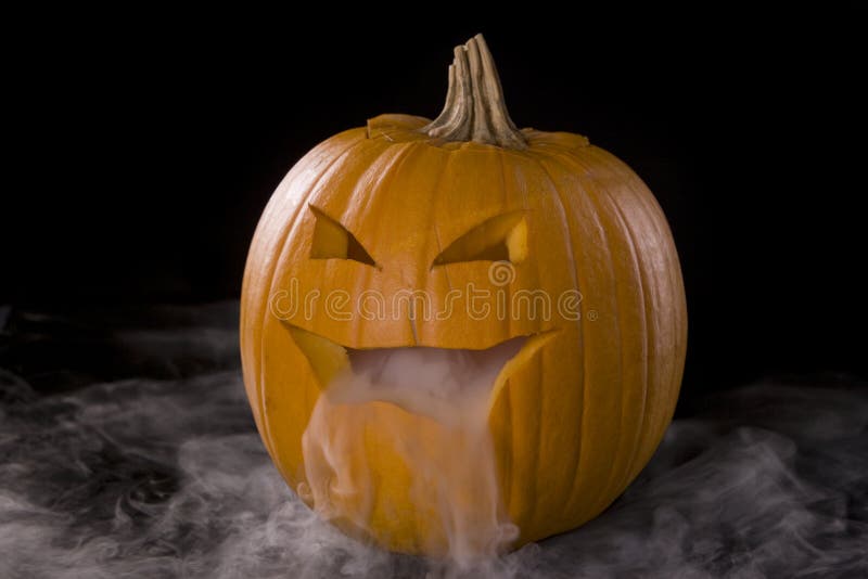 Horizontal image of a Jack-o-Lantern with mist pouring from it's mouth. Horizontal image of a Jack-o-Lantern with mist pouring from it's mouth