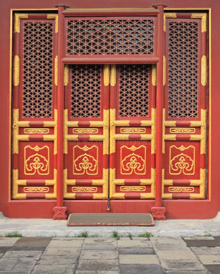 Very traditional chinese red doors with golden painting.Location:Beijing,China. Very traditional chinese red doors with golden painting.Location:Beijing,China.