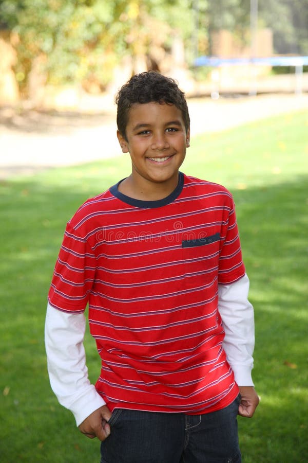 Portrait of 11 year old boy outdoors, looking at camera. Portrait of 11 year old boy outdoors, looking at camera