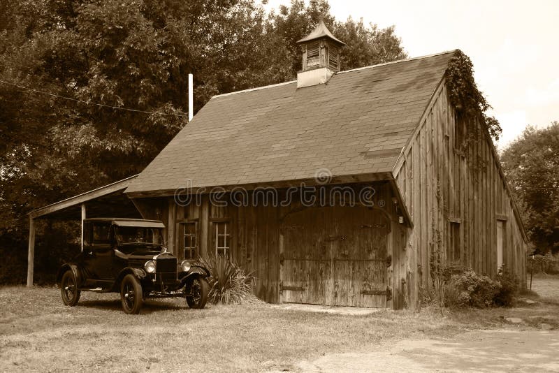 1927 Model T Ford coupe parked in front of an old barn, sepia tone. 1927 Model T Ford coupe parked in front of an old barn, sepia tone.