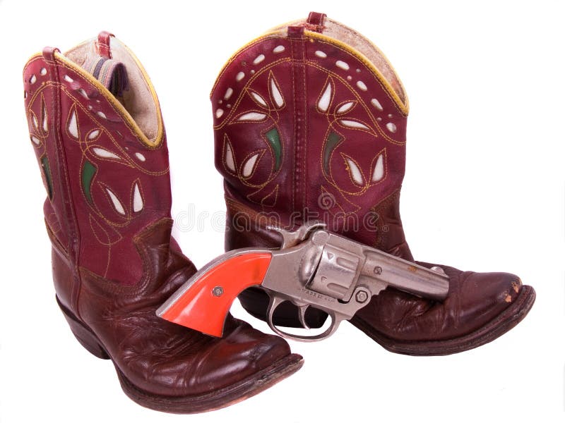 1950s child's cowgirl boots and cap pistol stock images 1950s child's cowgirl boots and cap pistol stock images