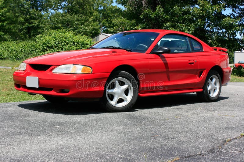 1994 red Ford Mustang coupe, GT model with 5-star pattern wheels. 1994 red Ford Mustang coupe, GT model with 5-star pattern wheels.