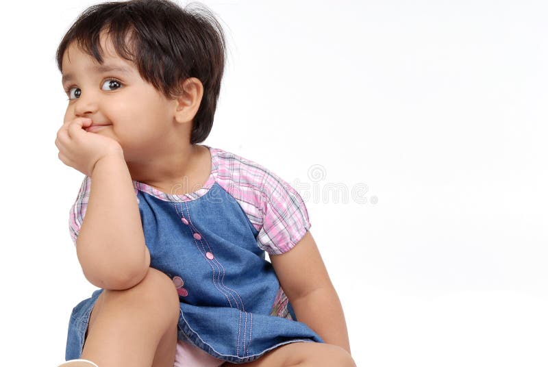 2-3 years old baby girl thinking over white background. 2-3 years old baby girl thinking over white background