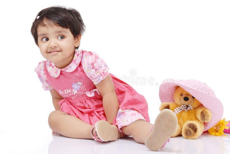 2-3 old year baby girl securing teddy bear. 2-3 old year baby girl securing teddy bear