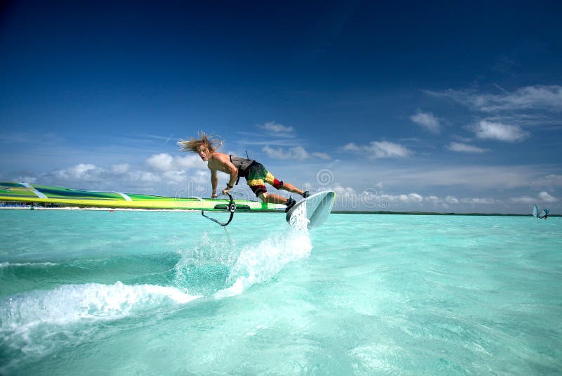 Pro windsurfer performing tricks, Bonaire, Dutch Antilles, Caribbean islands. Pro windsurfer performing tricks, Bonaire, Dutch Antilles, Caribbean islands.