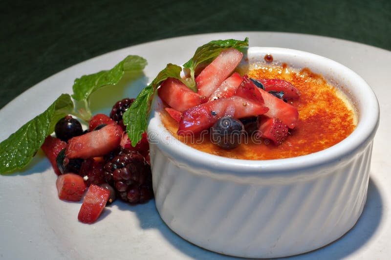 Creme Brulee with fresh fruit and mint leaves. Creme Brulee with fresh fruit and mint leaves