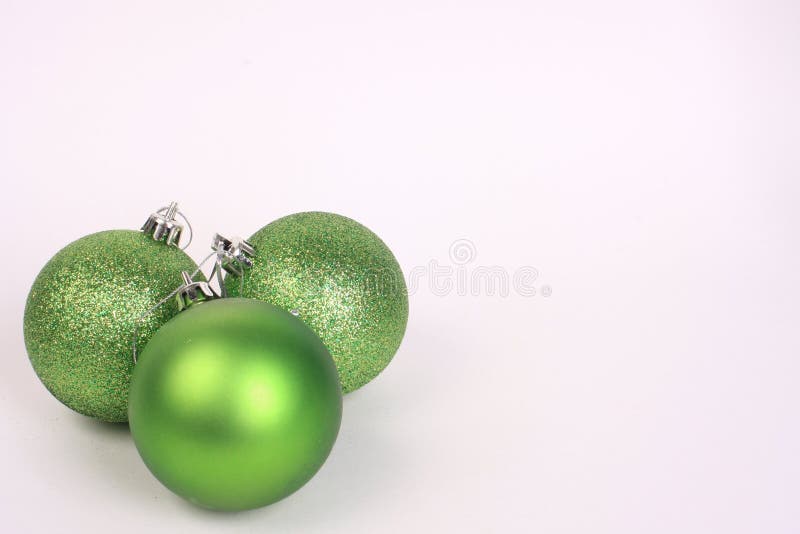 Three green christmas ornaments together. Three green christmas ornaments together