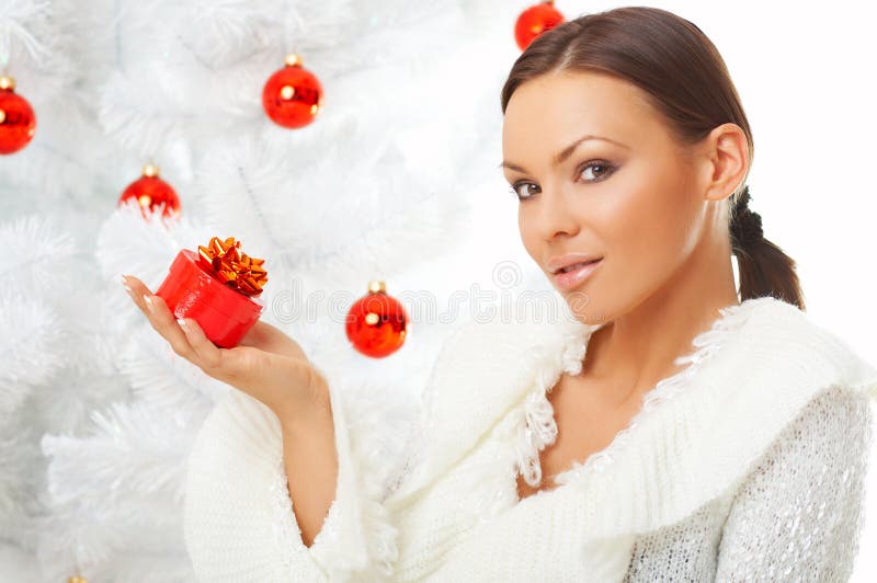 20-25 years old beautiful woman next to christmas tree on white background. 20-25 years old beautiful woman next to christmas tree on white background