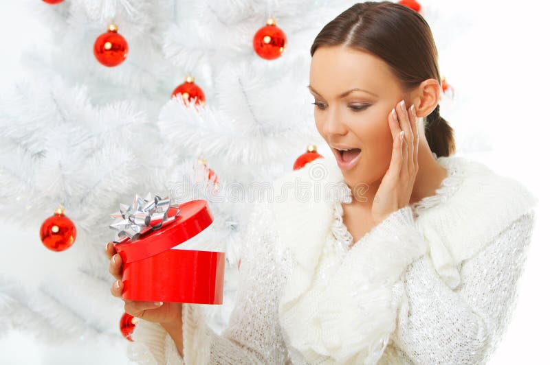 20-25 years old beautiful woman next to christmas tree on white background. 20-25 years old beautiful woman next to christmas tree on white background