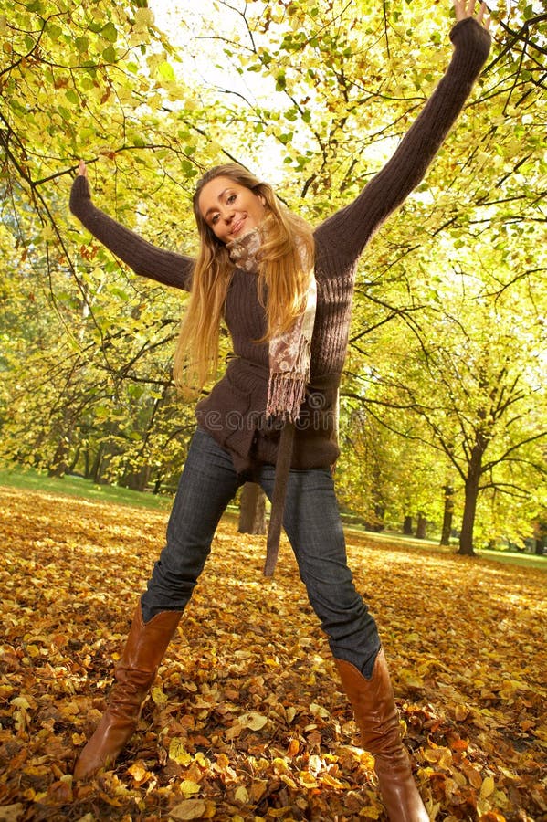 20-25 years old beautiful woman portrait having fun in natural autumn outdoors. 20-25 years old beautiful woman portrait having fun in natural autumn outdoors