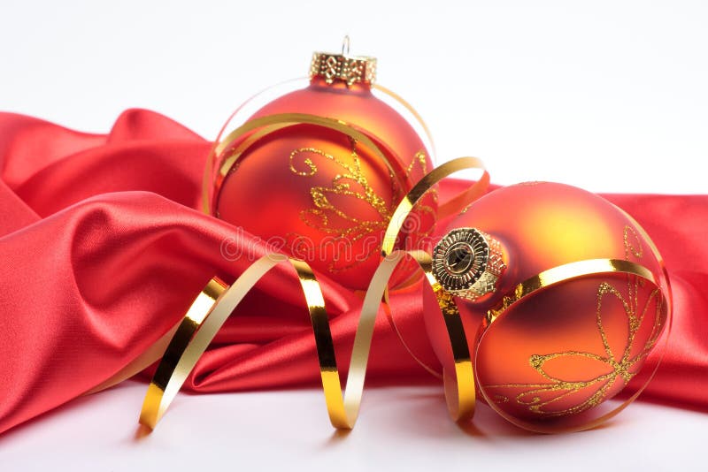 Christmas. New Year's spheres lie on red silk with a gold tape. Christmas. New Year's spheres lie on red silk with a gold tape.