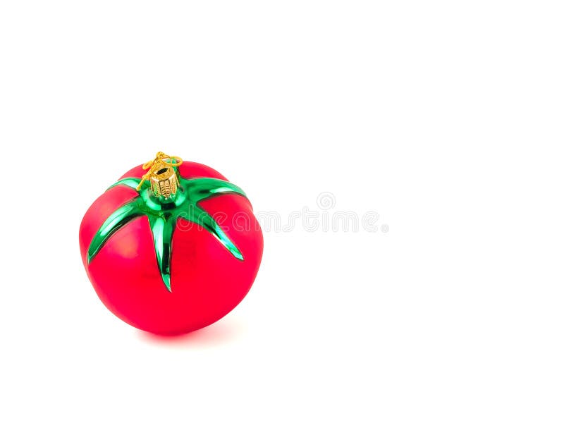 A glass, Christmas ornament in the shape of a red, ripe tomato. A glass, Christmas ornament in the shape of a red, ripe tomato.