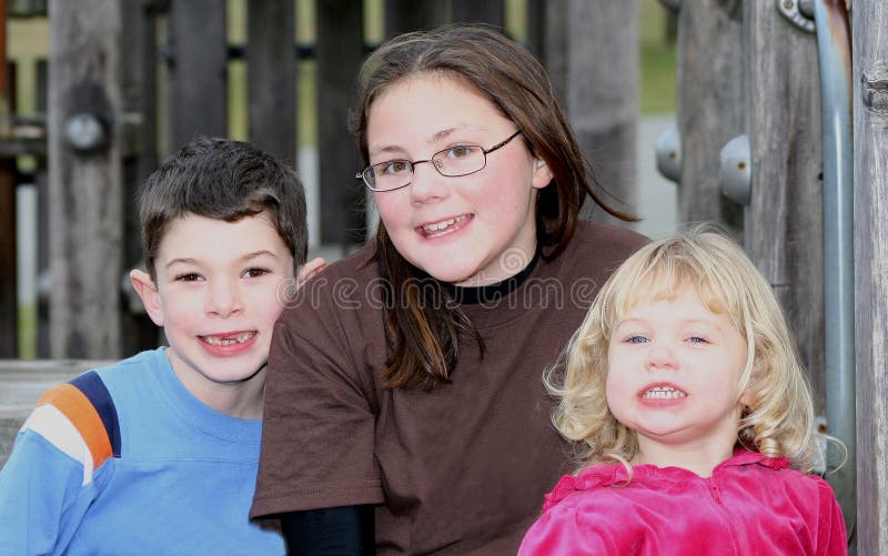 Three happy cousins sitting together at park. Three happy cousins sitting together at park.