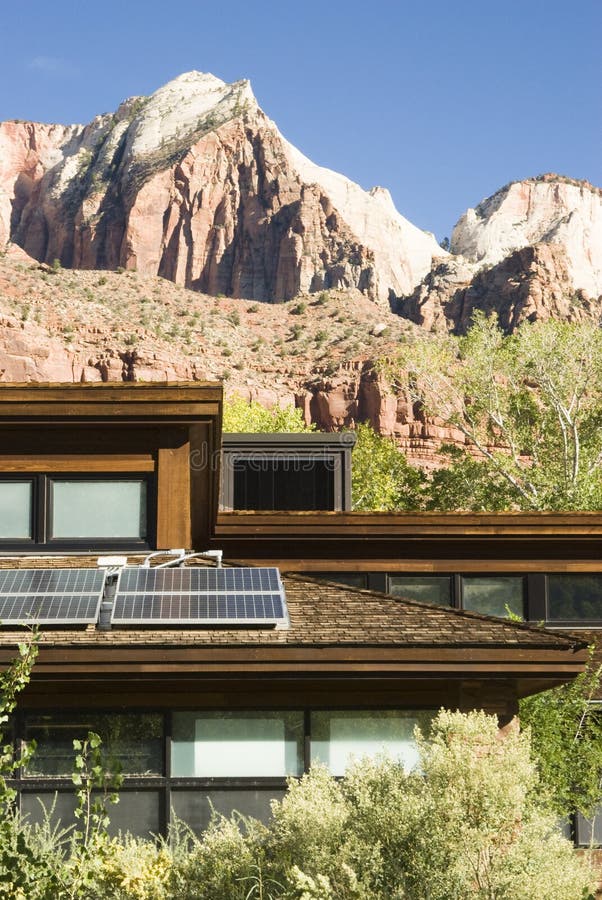 Solar panels attached to the roof of the visitor's center in Zion National Park in southwest Utah. Sandstone formations in the background. Solar panels attached to the roof of the visitor's center in Zion National Park in southwest Utah. Sandstone formations in the background.