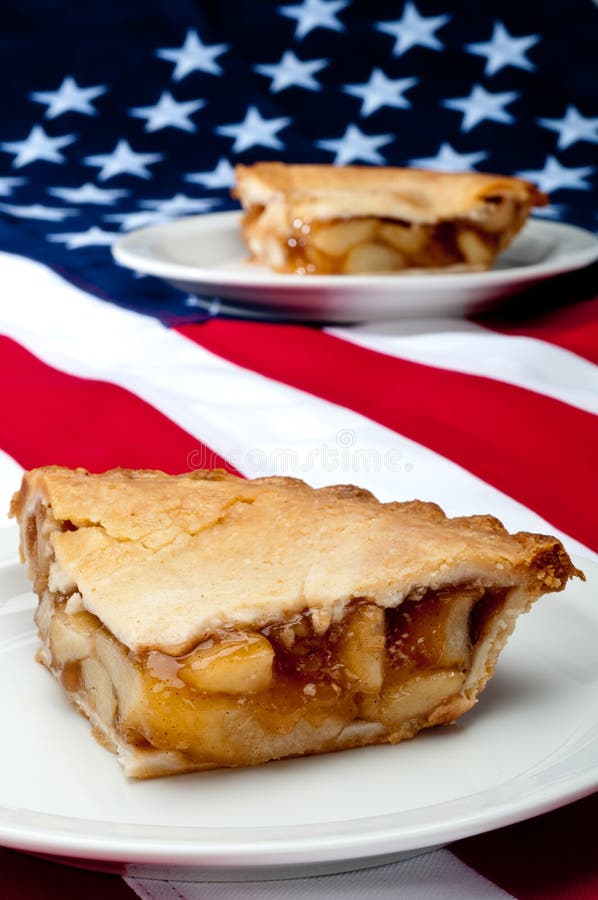 Shallow focus vertical image of 2 pcs of apple pie on the American flag. Shallow focus vertical image of 2 pcs of apple pie on the American flag