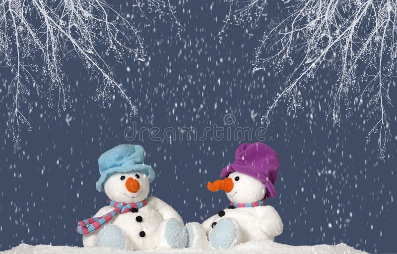 2 snowman sitting in the snow stock photos