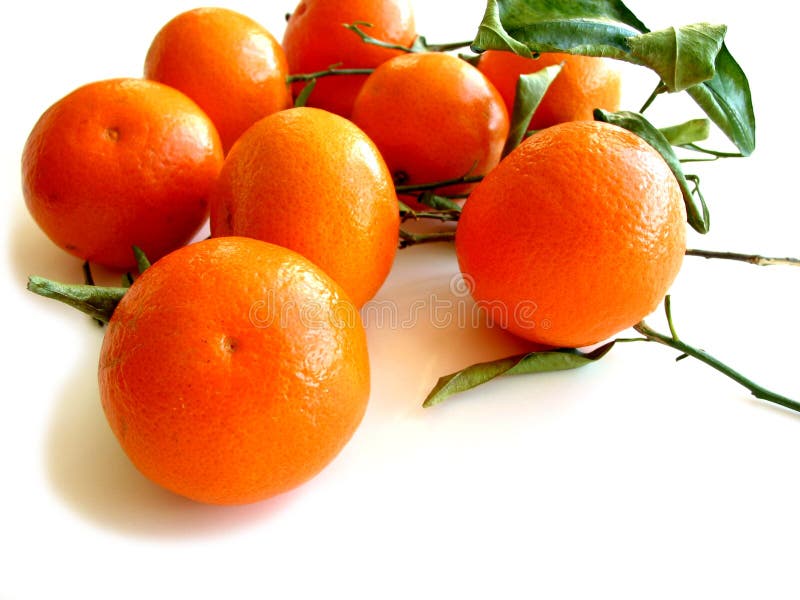 Orange tangerines with green leaves isolated on white background. Orange tangerines with green leaves isolated on white background