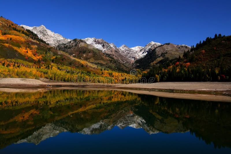 High mountain lake in the fall showing autumn colors reflected in the water. High mountain lake in the fall showing autumn colors reflected in the water