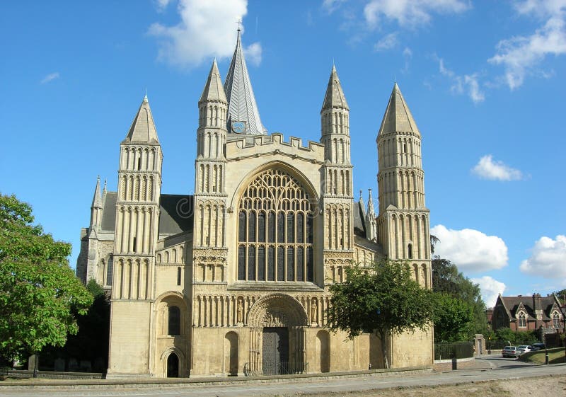 Rochester cathedral from the front showing the main entrance plus buildings and trees the side. Rochester cathedral from the front showing the main entrance plus buildings and trees the side