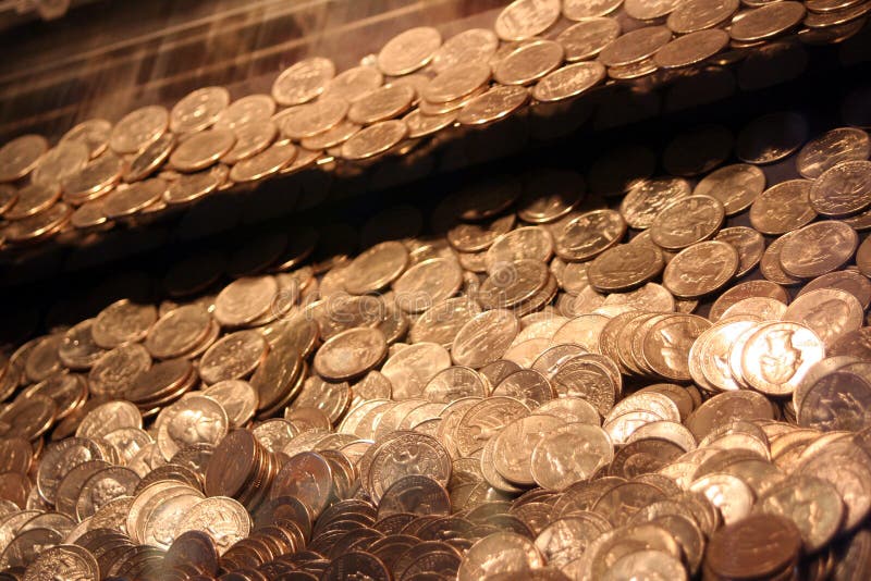 Angled shot of quarters inside an arcade game. Angled shot of quarters inside an arcade game.