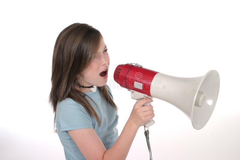 Young child or tween girl shouting, speaking, or singing through a megaphone. Shot on white. Young child or tween girl shouting, speaking, or singing through a megaphone. Shot on white